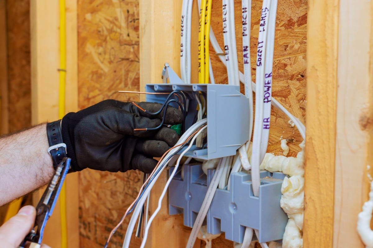 Electrician working on circuit board during house rewire